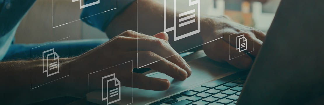 Person types on a laptop with animated file graphics in the air